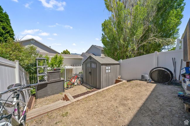 Fenced backyard featuring a storage shed | Image 24