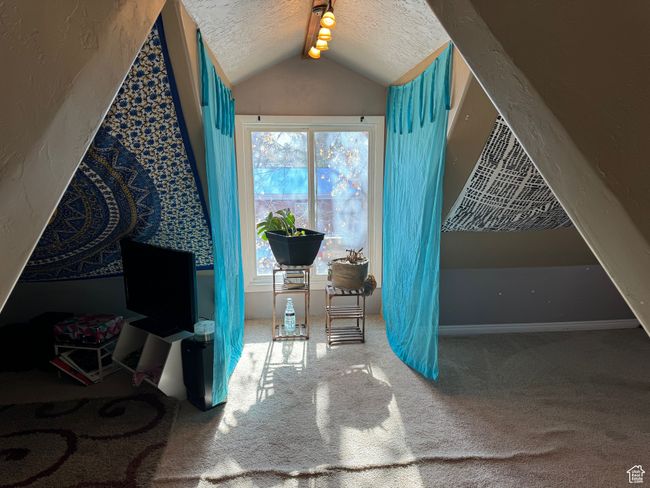 Interior space featuring vaulted ceiling, a textured ceiling, and carpet flooring | Image 32