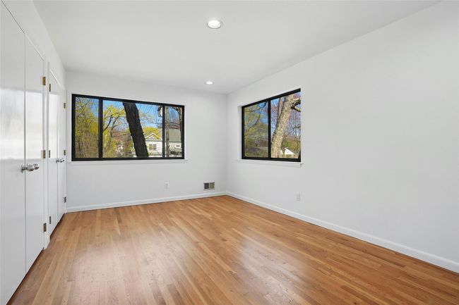 Bedroom with multiple windows and two double closets. | Image 26