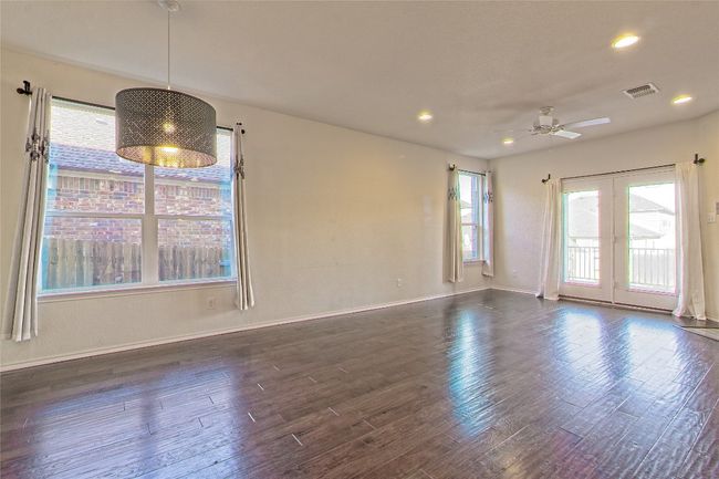 Unfurnished room with dark wood finished floors, a ceiling fan, recessed lighting, and french doors | Image 13