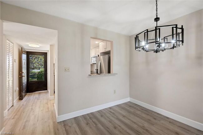 Entrance foyer featuring light hardwood / wood-style flooring and a chandelier | Image 10
