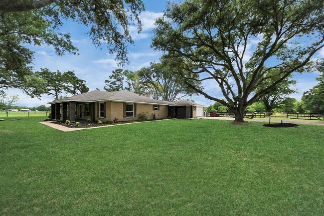 Expansive front yard with mature trees and wide-open space to roam. | Image 28