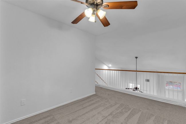 Unfurnished room with carpet floors, ceiling fan, and vaulted ceiling | Image 22