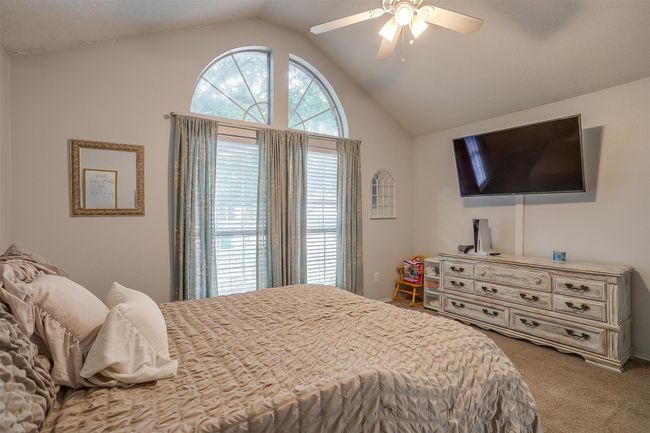 Bedroom with carpet flooring, lofted ceiling, and ceiling fan | Image 27