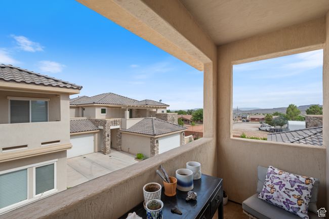 Primary bedroom balcony with a residential view and a mountain view | Image 20