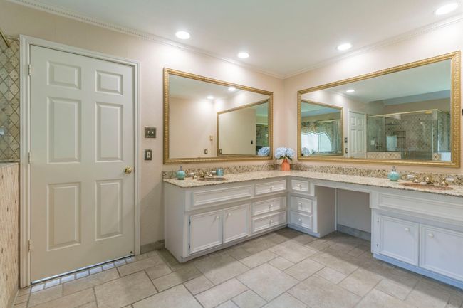 Full bath with ornamental molding, double vanity, a shower stall, and stone finish flooring | Image 14