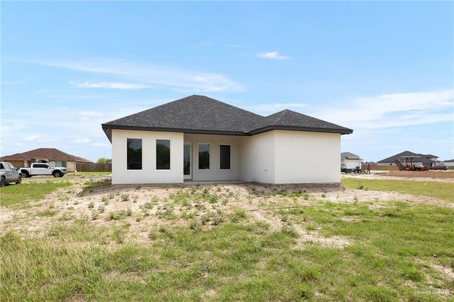 Back of property with stucco siding and a shingled roof | Image 14