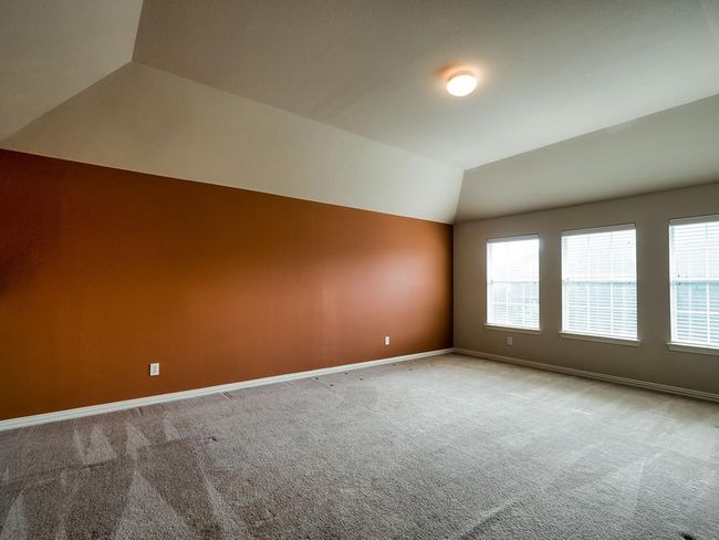 Empty room with vaulted ceiling, carpet floors, healthy amount of natural light, and baseboards | Image 34