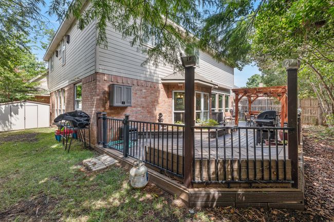 Backyard faces east = morning sun! Plenty of room for dogs or water tables in the grassy area on each side of the deck. | Image 36