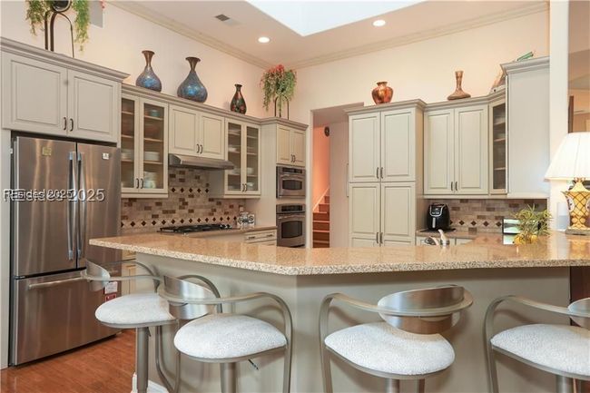 Lovely updated Kitchen with Dacor gas cooktop and vent, GE Profile Convection oven and Microwave Convection Oven. | Image 28
