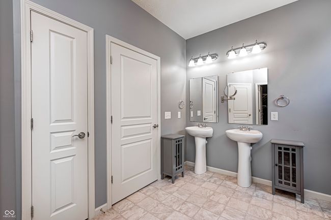 Primary Bath with separate toilet space, shower and linen closet. A separate sink design was put in to facilitate potential, future wheelchair ease of use. | Image 24