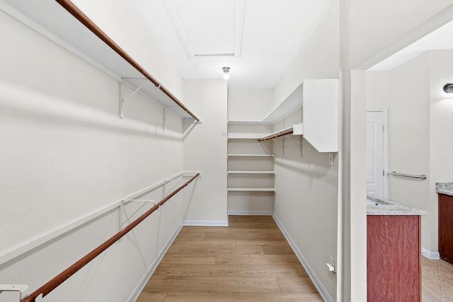 Walk in closet with light wood-type flooring | Image 32