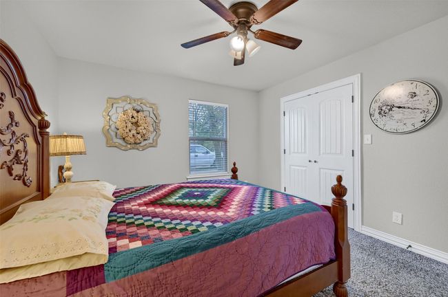 Bedroom with baseboards, a closet, ceiling fan, and carpet | Image 25