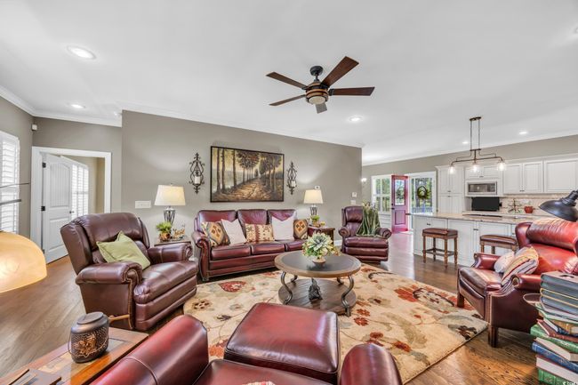 Living area with ornamental molding, ceiling fan, wood finished floors, and recessed lighting | Image 7