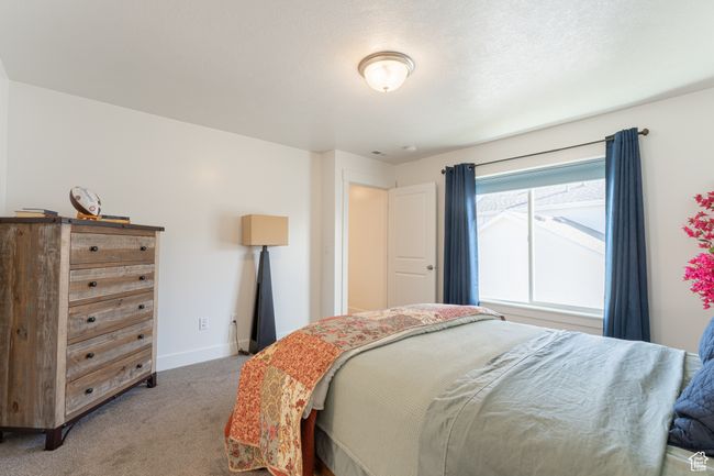 Bedroom featuring light carpet and baseboards | Image 10