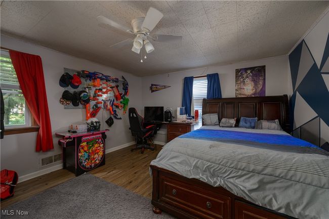 Bedroom with wood finished floors and ceiling fan | Image 16