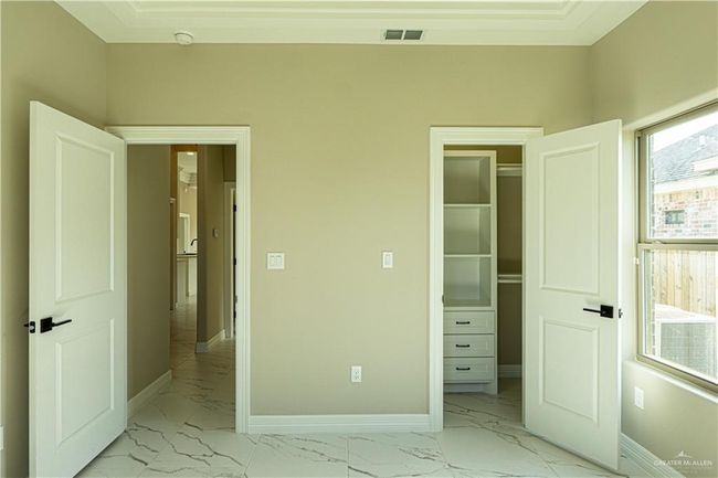 Unfurnished bedroom with marble finish floor, visible vents, and baseboards | Image 18