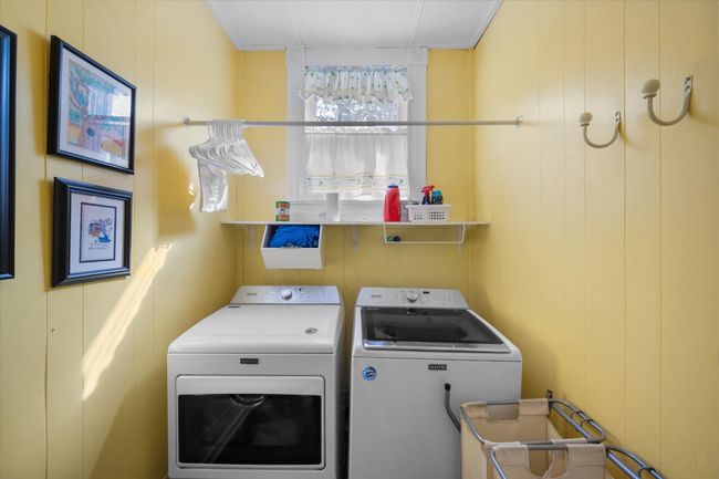 Washroom with washer and clothes dryer and a decorative wall | Image 18