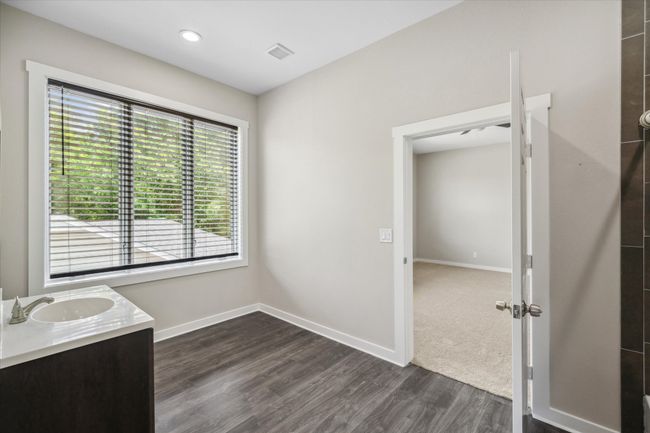 Bathroom with wood finished floors, vanity, and baseboards | Image 28