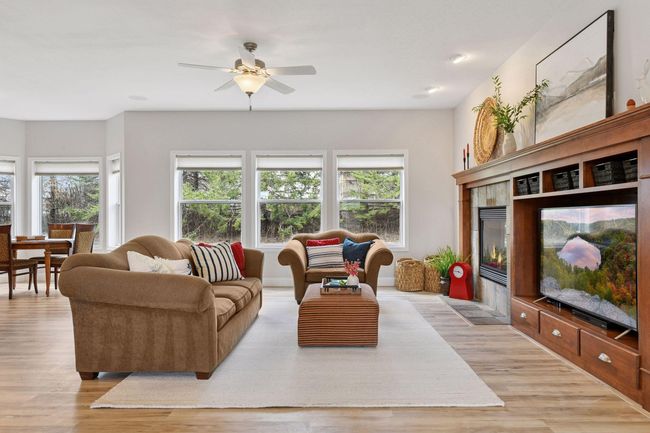 Main floor family with large windows overlooking a private backyard. | Image 5