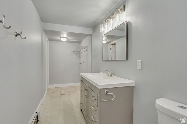 Bathroom with vanity, toilet, and baseboards | Image 14