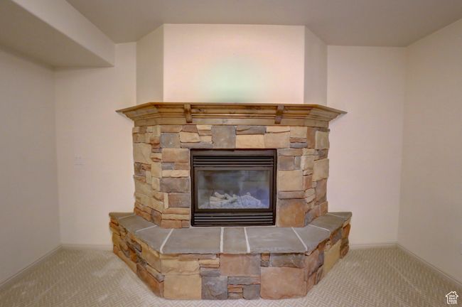 Interior details with a fireplace, baseboards, and carpet floors | Image 41