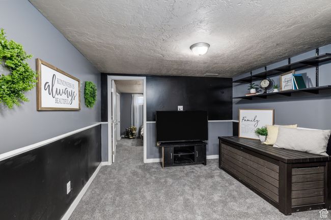 Newly carpeted living area featuring a textured ceiling | Image 17