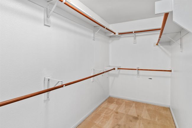 Walk in closet featuring light carpet | Image 14