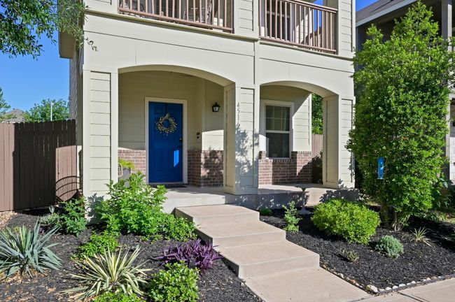 Entrance to property with brick siding, fence, a balcony, and a porch | Image 5