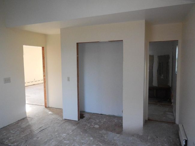 Spare room featuring baseboard heating | Image 13