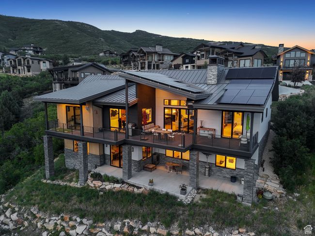 Rear view of house featuring a standing seam roof, a metal roof, and a patio area | Image 83