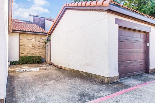 View of side of home featuring a tile roof and stucco siding | Image 12