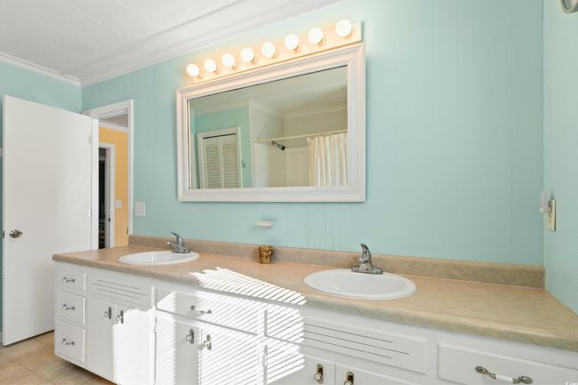 Bathroom featuring tile patterned flooring, vanity, and crown molding | Image 22