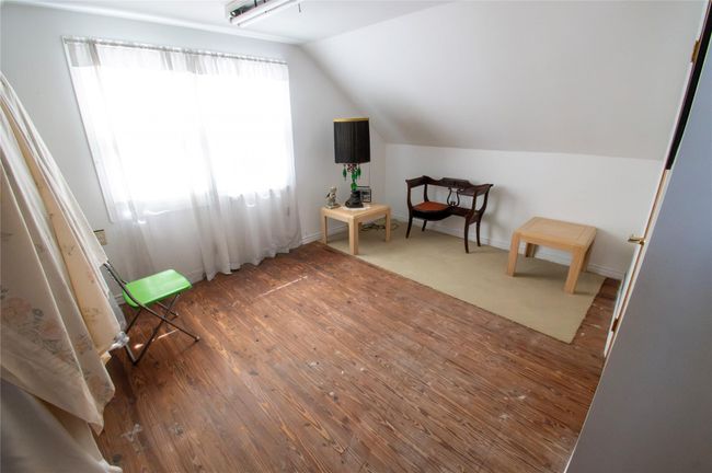 Sitting room featuring lofted ceiling and wood-type flooring | Image 20