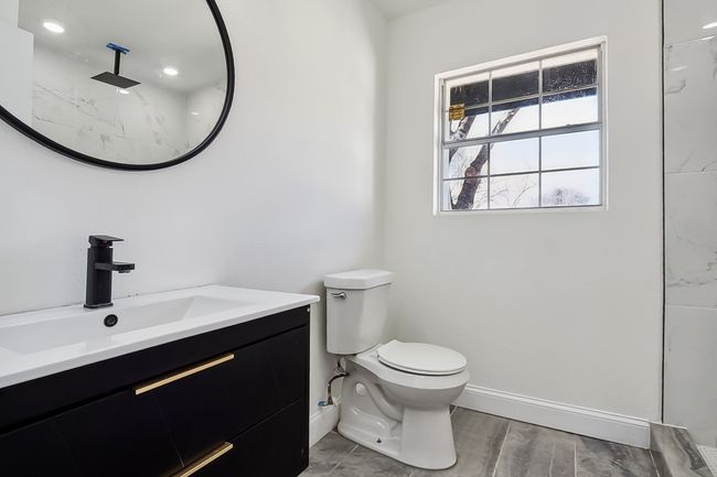 Bathroom featuring toilet, baseboards, wood finished floors, and vanity | Image 20