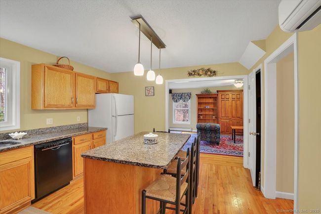 Granite counters, hardwood floors, island with seating for four | Image 4