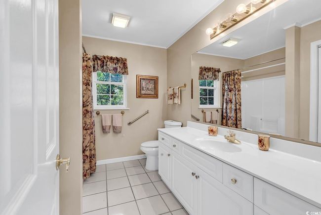 Full bathroom with vanity, tile patterned flooring, ornamental molding, and curtained shower | Image 18