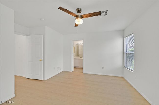Spare room featuring light wood-style floors and a ceiling fan | Image 11