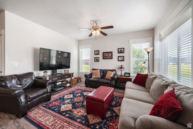 Living room with a ceiling fan | Image 10