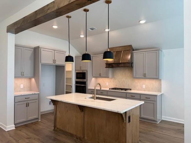 Kitchen with a sink, dark wood-style floors, gray cabinets, and stainless steel appliances | Image 8