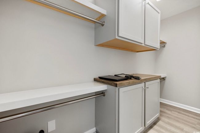 Walk in closet featuring light wood-style floors | Image 14