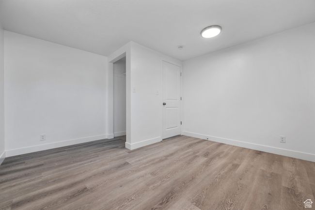 Empty room with wood finished floors and baseboards | Image 10
