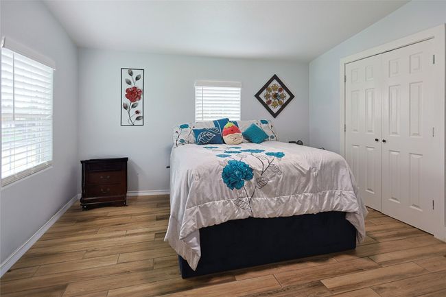 Bedroom featuring baseboards, a closet, and wood finished floors | Image 12