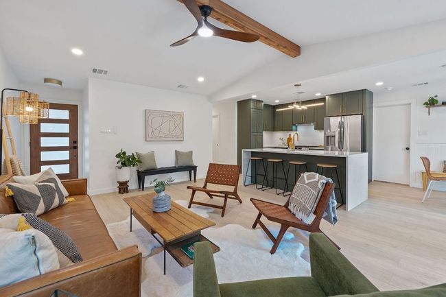 Living area featuring light wood-type flooring, recessed lighting, ceiling fan, and a chandelier | Image 6