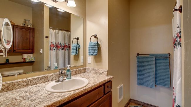 Primary Bathroom offers walk-in shower, extra storage cabinets and electric wall heater | Image 8