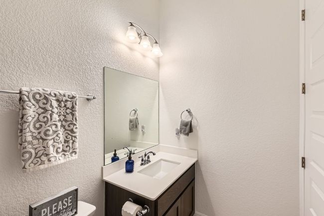 Bathroom with vanity and a textured​​‌​​​​‌​​‌‌​‌‌​​​‌‌​​‌‌​‌​​​​​‌ wall | Image 23