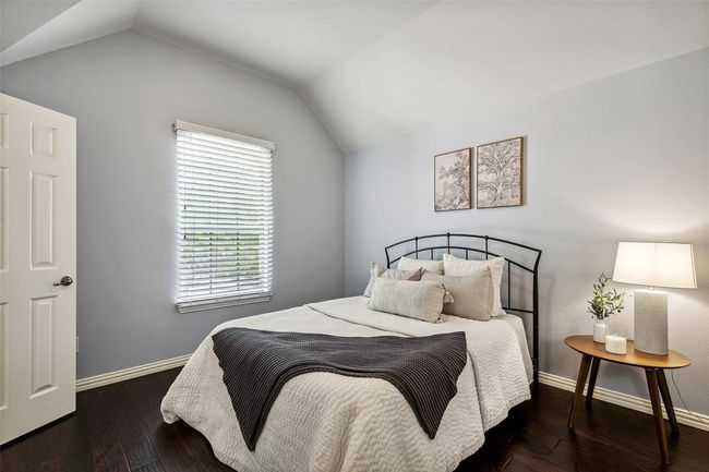 Bedroom featuring lofted ceiling and dark wood-type flooring | Image 23