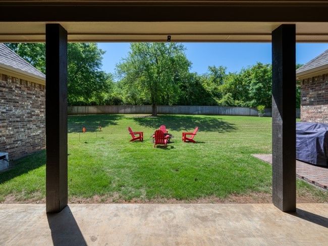 View of yard featuring a fenced backyard and a patio | Image 34
