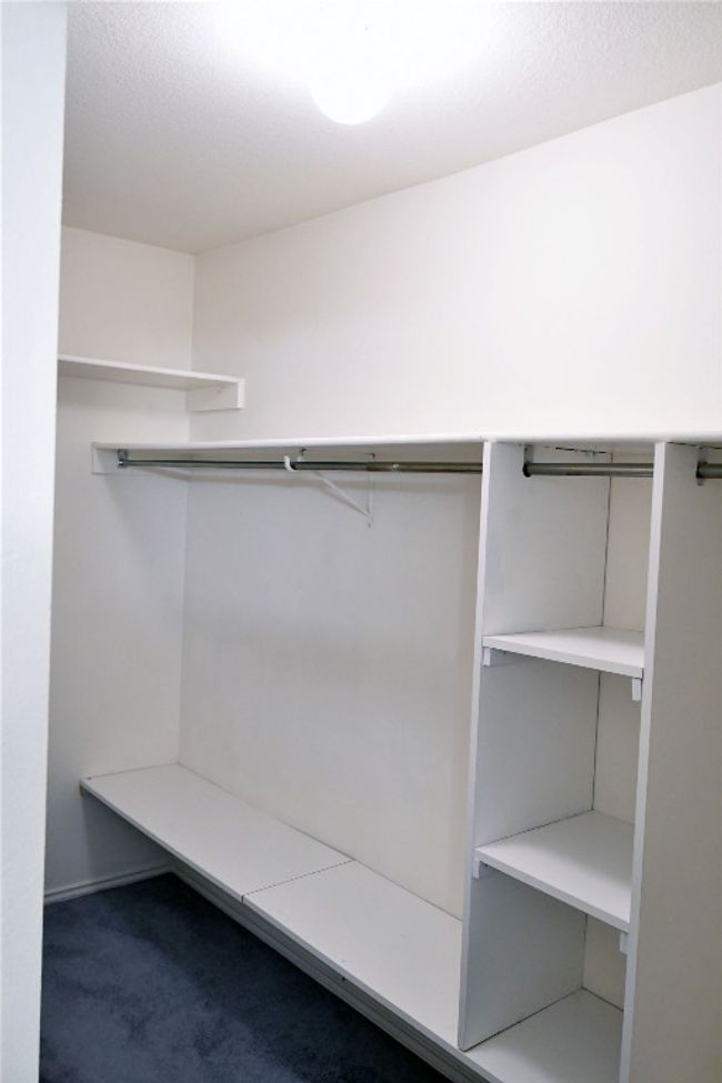 Spacious closet with carpet flooring | Image 17