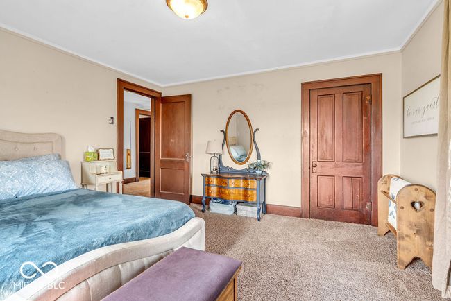 bedroom with carpet floors and crown molding | Image 37